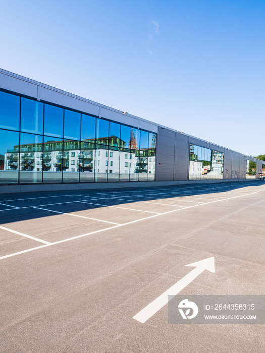 Empty parking in front of an aluminium cladding modern building