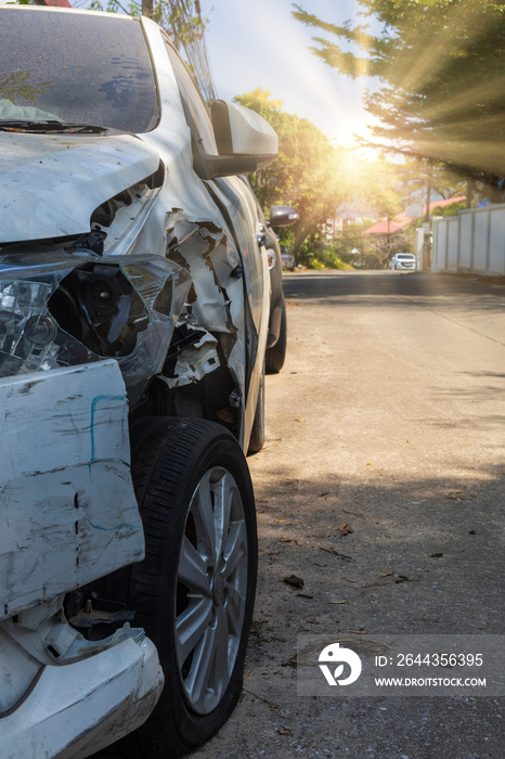 Front of white color car big damaged and broken by accident on city street parking can not drive any more. With copy space for text or design