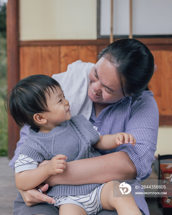 Portrait image of Asian Chinese mother with Happy 1-2 years kids during holiday at Kundasang Town, Sabah, Borneo