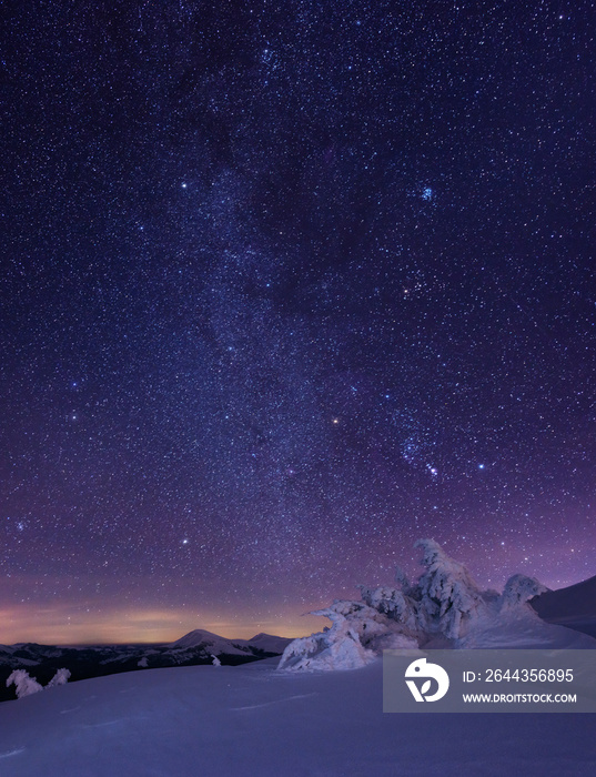 Night starry sky in winter mountains