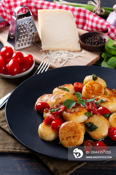 Artisan gnocchi stuffed with cheese, with cherry tomatoes, garlic, olive oil and basil