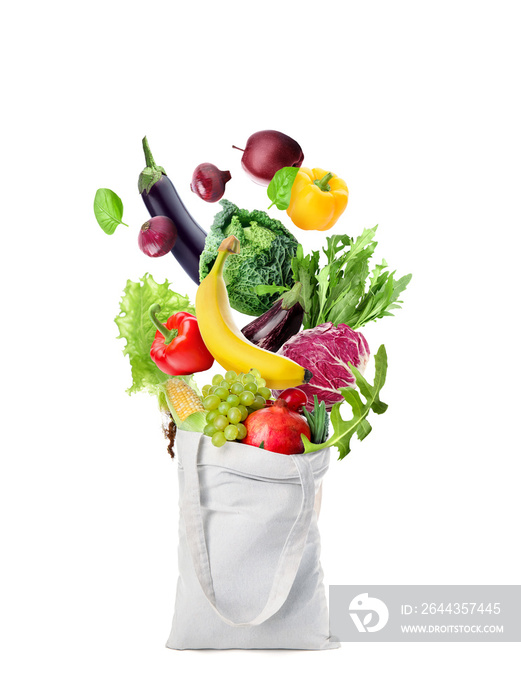 Shopping bag with flying fresh vegetables and fruits on white background