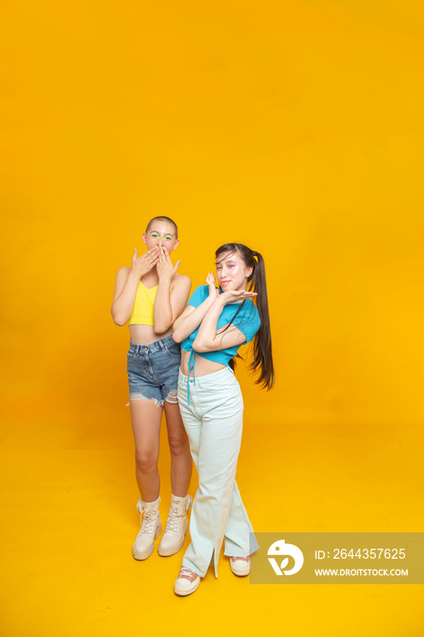 Studio portrait of smiling stylish friends gesturing