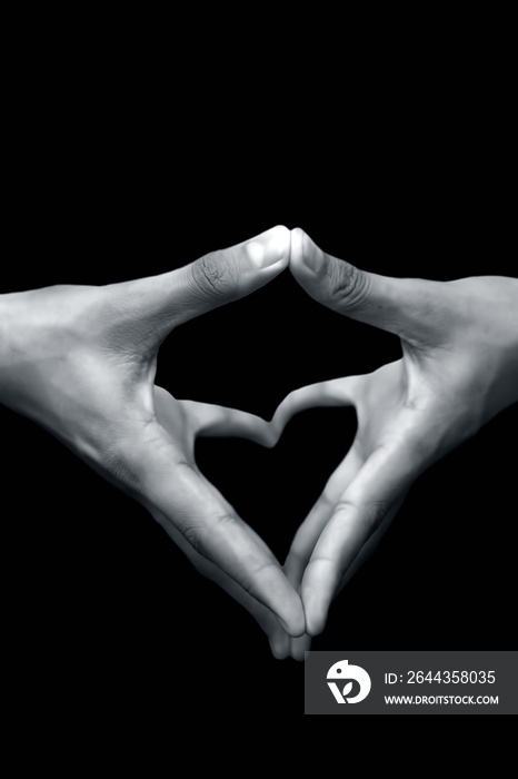 Close up shot of pair of human hands with open hands stretched and doing Yoni Mudra or Feminine adi shakti hand gesture isolated on black background.