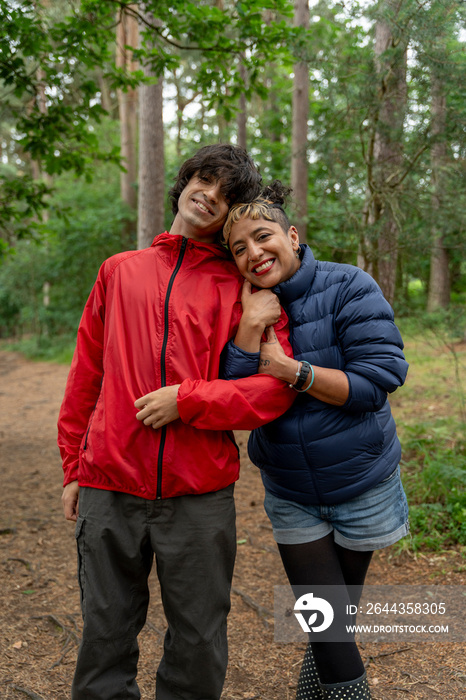 Portrait of mother and son hiking in forest
