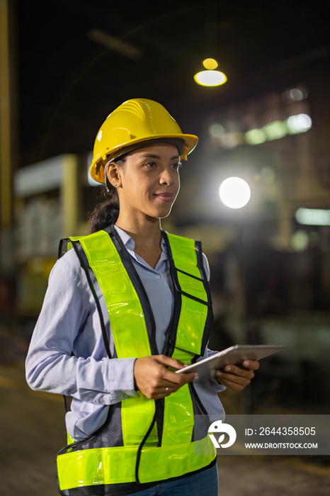 African american factory woman worker or technician stand with confident action in heavy industry engineers steel metal manufacturing factory engineering or construction site.