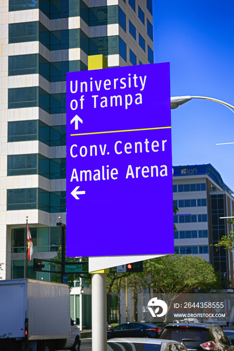 Signpost in downtown Tampa pointing to the University and Convention Center in FL