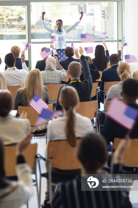 Young businesswoman doing speech and celebrating victory in conference room