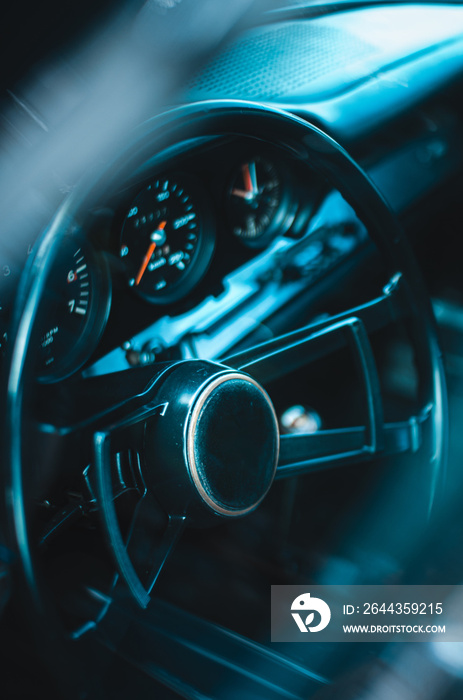 Newtimer car dashboard. Retro car interior. Old steering wheel detail.