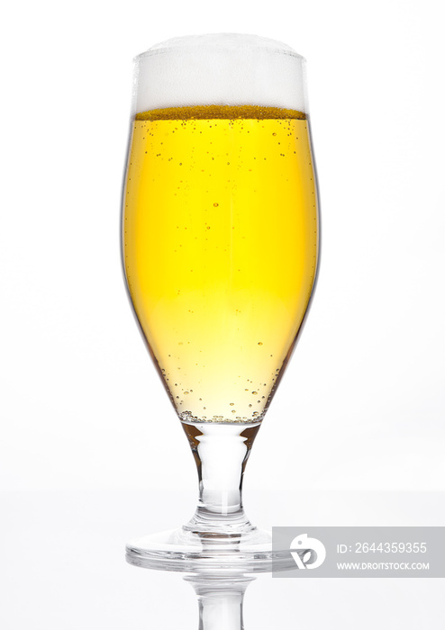 Glass of beer cider with foam golden color white