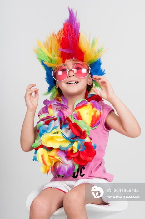 Funny little girl in disguise with wig and sunglasses