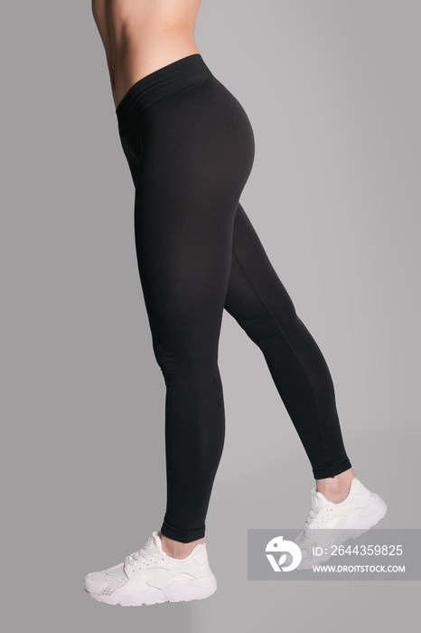 Woman in leggings and sneakers, low section. athletic ass