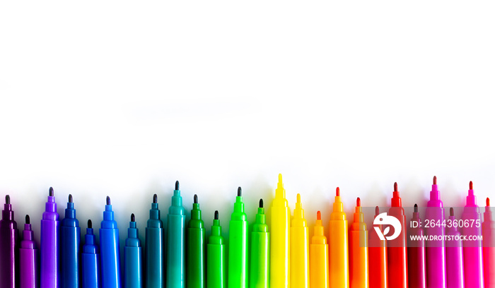 Felt-tip pens on a white background. Multi-colored markers are beautifully folded by the color of the rainbow. Creativity and design concept.