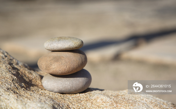 Conceptual background of three stacked river rocks