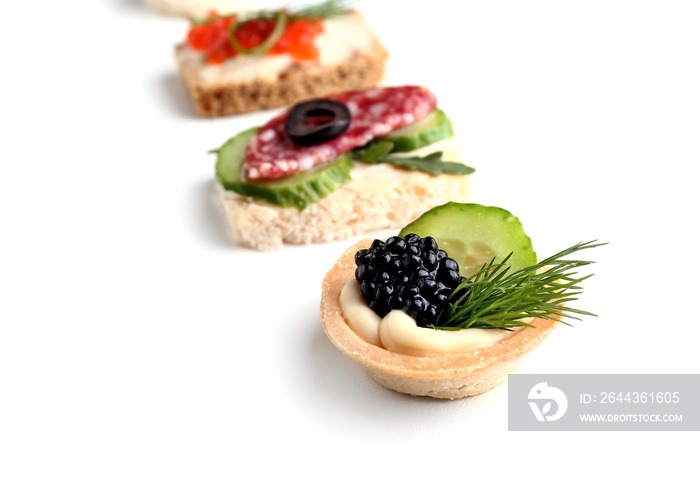 Assortment of tasty canapes on white background