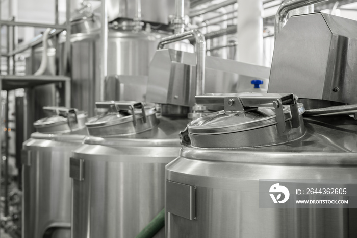 storage and pasteurization tank at the milk factory. equipment at the dairy plant