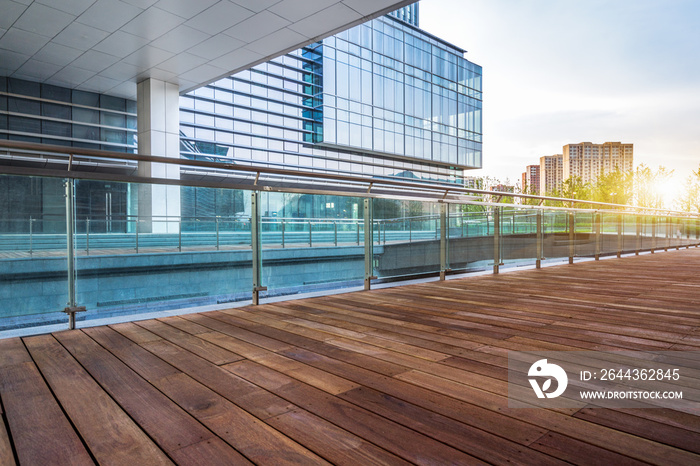 Empty wooden footpath front modern building