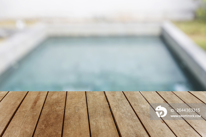 Wood table top and blurred swimming pool background. - can used for display or montage your products.