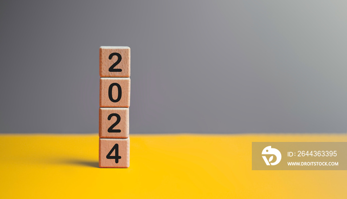 2024 New year goal planning idea concept, number in wooden block cubes. Gray and yellow background with copy space.