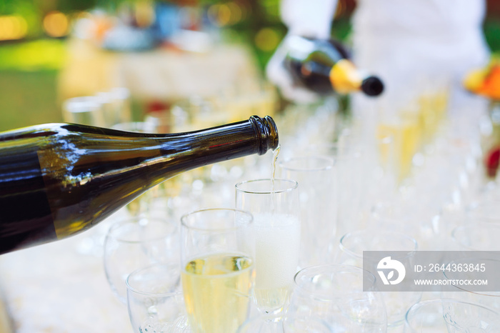 Bartender pouring champagne into glasses