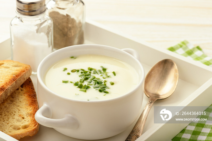 Cheese cream soup on white wooden  tray.