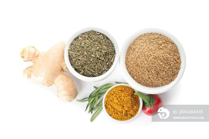 Bowls with different spices on white background