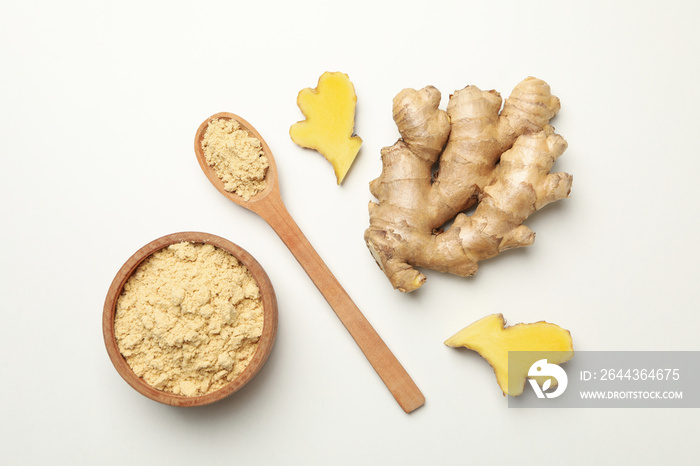 Ginger and bowl with ginger powder on white background