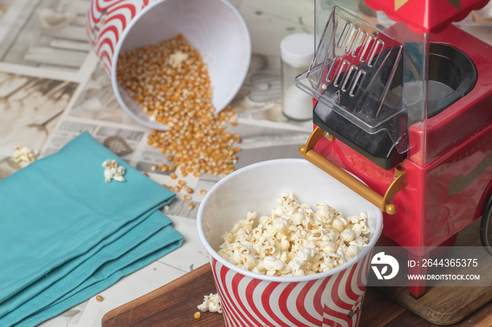 popcorn machine and bucket on a wooden table