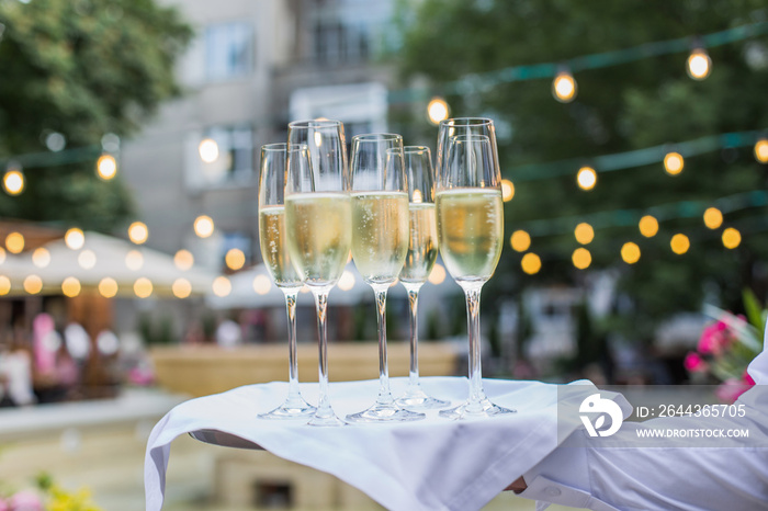 Catering service waiter holding a tray with Glasses of Wine Prosecco and Champagne for tasting