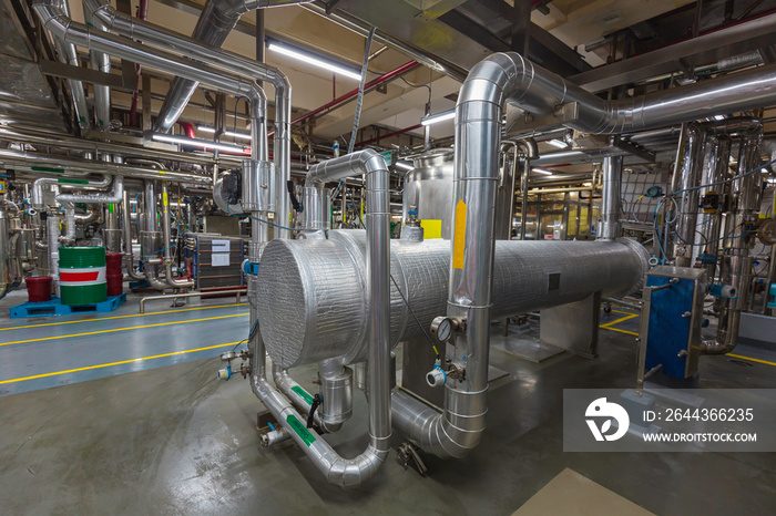 Process heat exchanger at the insulation in process area of pipeline flowing stainless chemical in a factory at control room