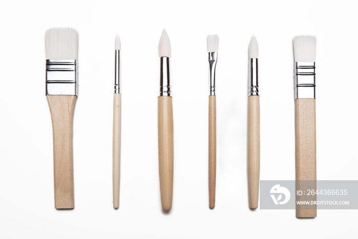 Paint brushes new clean with wooden handle isolated against white background.