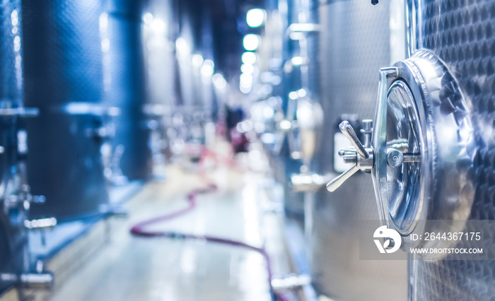 Metal vats for fermentation. Wine factory. Steel barrels in winery.