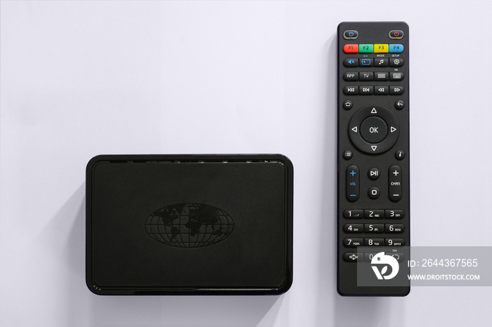 Iptv box and remote controller. Modern multimedia device for viewing television via the Internet, multimedia player and control panel.