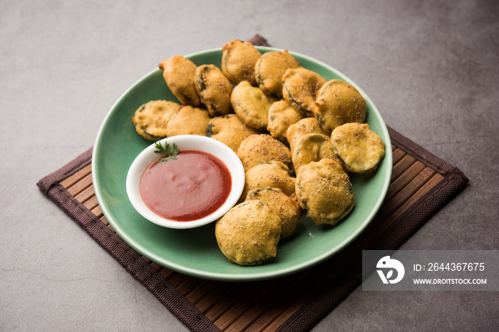 Sponge gourd fritters or gilki bhaji or bajji or pakora is an Indian snack item, served with tomato ketchup, selective focus