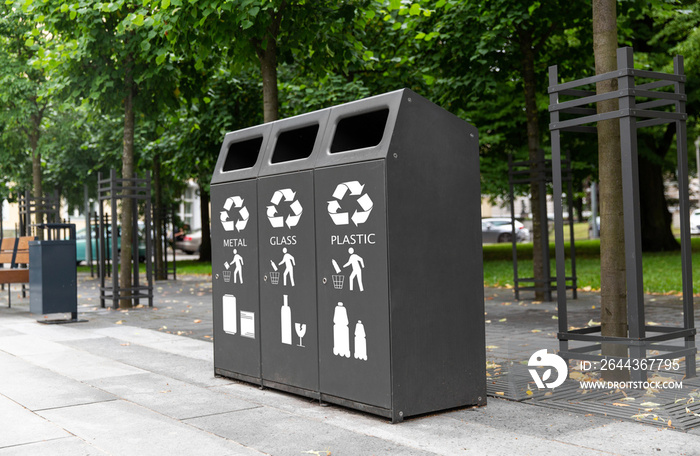 recycling and garbage concept - trash container for metal, glass and plastic waste sorting on city street