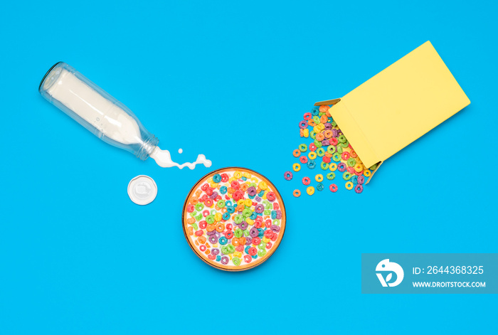 Cereal bowl with milk, top view. Breakfast with multicolored cereals and milk.