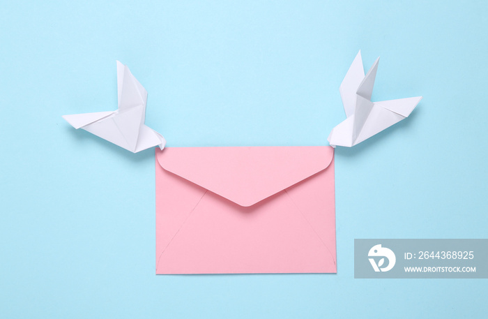 Origami carrier pigeons with envelope on a blue background