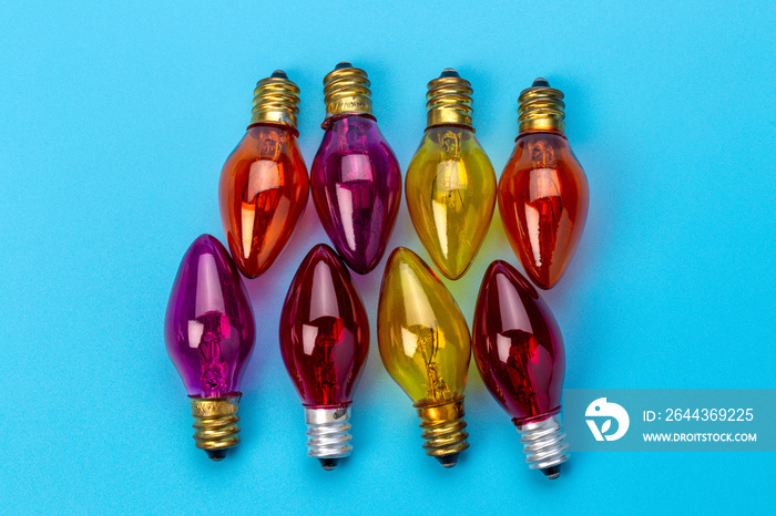 Set of colorful light bulbs on blue background. top view