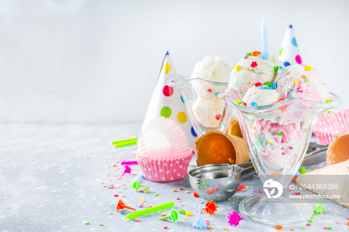 Colorful Birthday cake ice cream with Birthday decoration and ice cream waffle cones, white gray background copy space