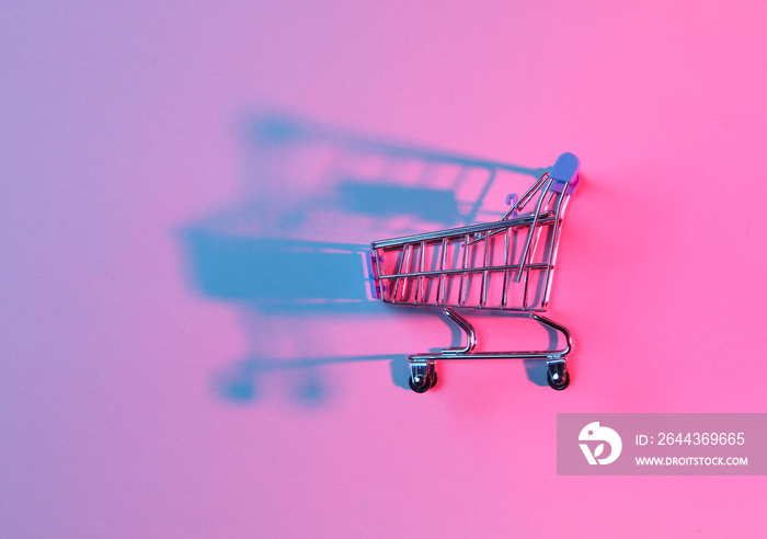 Toy shopping trolley with neon pink blue light. Retro style 80s, minimalism