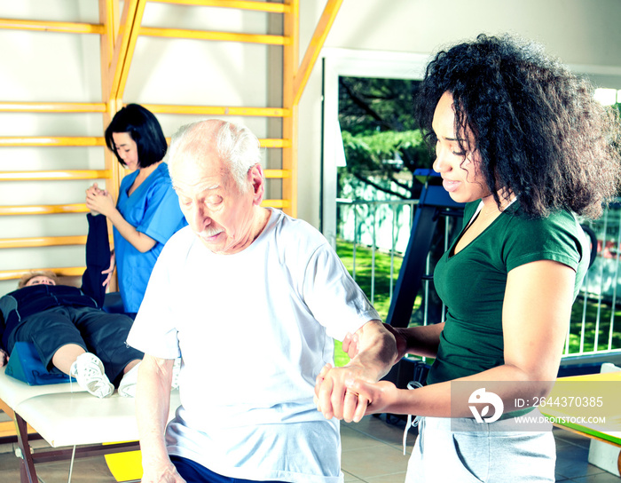 Elder people making exercises in a rehab clinic for ritired