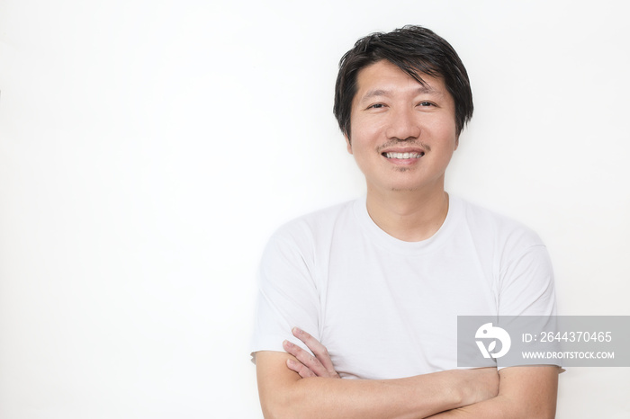 Attractive beautiful smiling positive asian happy man. Closeup portrait asian polite man wearing t-shirt with crossed arms isolated on white background.