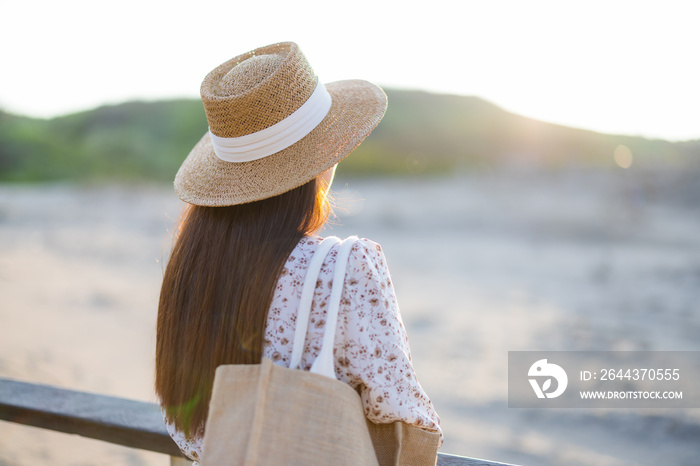 Travel woman look at the sea under sunset