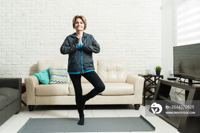 Active Elderly Woman Doing Yoga At Home