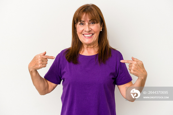 Middle age caucasian woman isolated on white background points down with fingers, positive feeling.