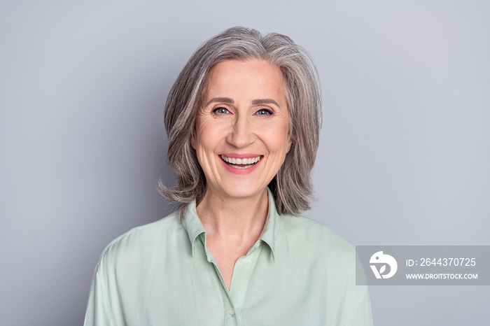 Photo of happy smiling cheerful laughing mature woman granny hear good joke isolated on grey color background