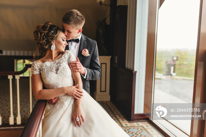 Wedding couple embrace on a background of luxury place