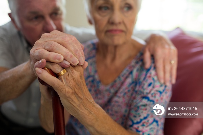 Senior man holding hands of old woman