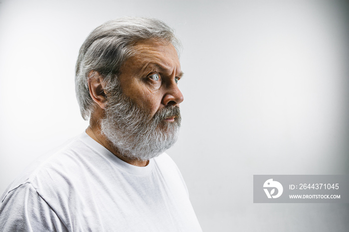 The senior attractive man looking suprised isolated on white