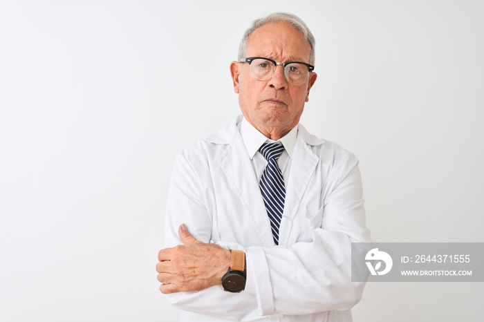 Senior grey-haired scientist man wearing coat standing over isolated white background skeptic and nervous, disapproving expression on face with crossed arms. Negative person.